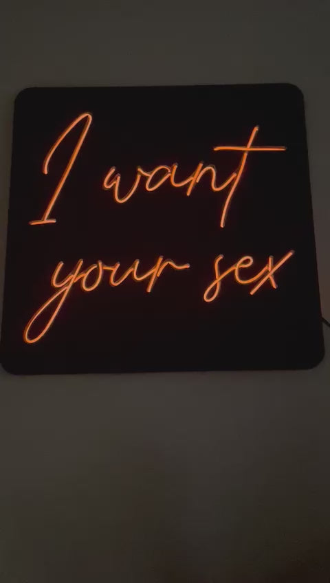 Wall sign with illuminated text I WANT YOUR SEX